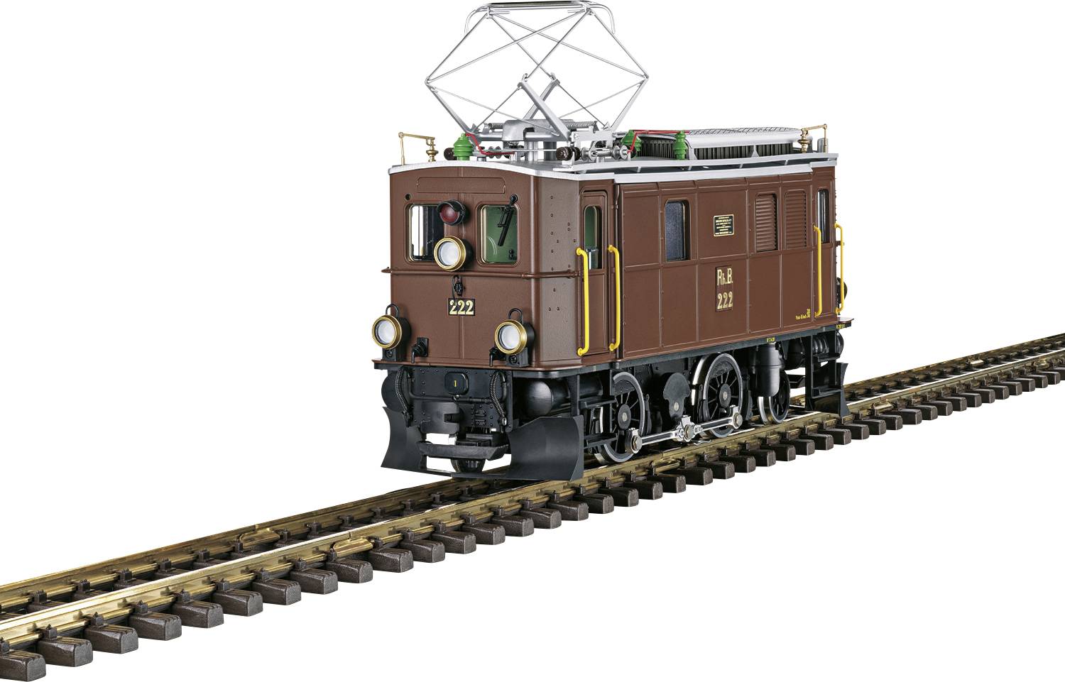 Historyczna brązowa lokomotywa na torach, prawdopodobnie z wczesnej epoki elektryfikacji, z charakterystycznymi okrągłymi reflektorami.