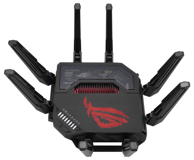 Czarno-czerwony router z ośmioma antenami przypominającymi nóżki pająka. Wskazuje na wysoką wydajność sieci i zasięg.