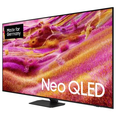 Telewizor z napisem 'Neo QLED' i 'Made for Germany', wyświetlający żywy różowo-żółty obraz krajobrazu na ekranie.