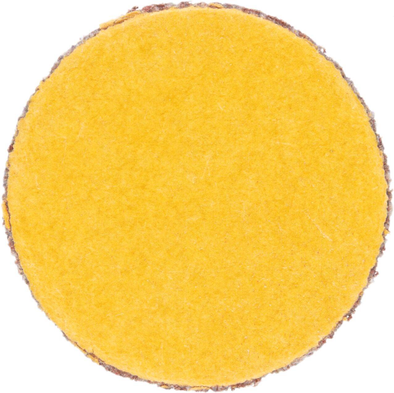 Żółta okrągła tarcza ścierna o szorstkich krawędziach, używana do wygładzania powierzchni.