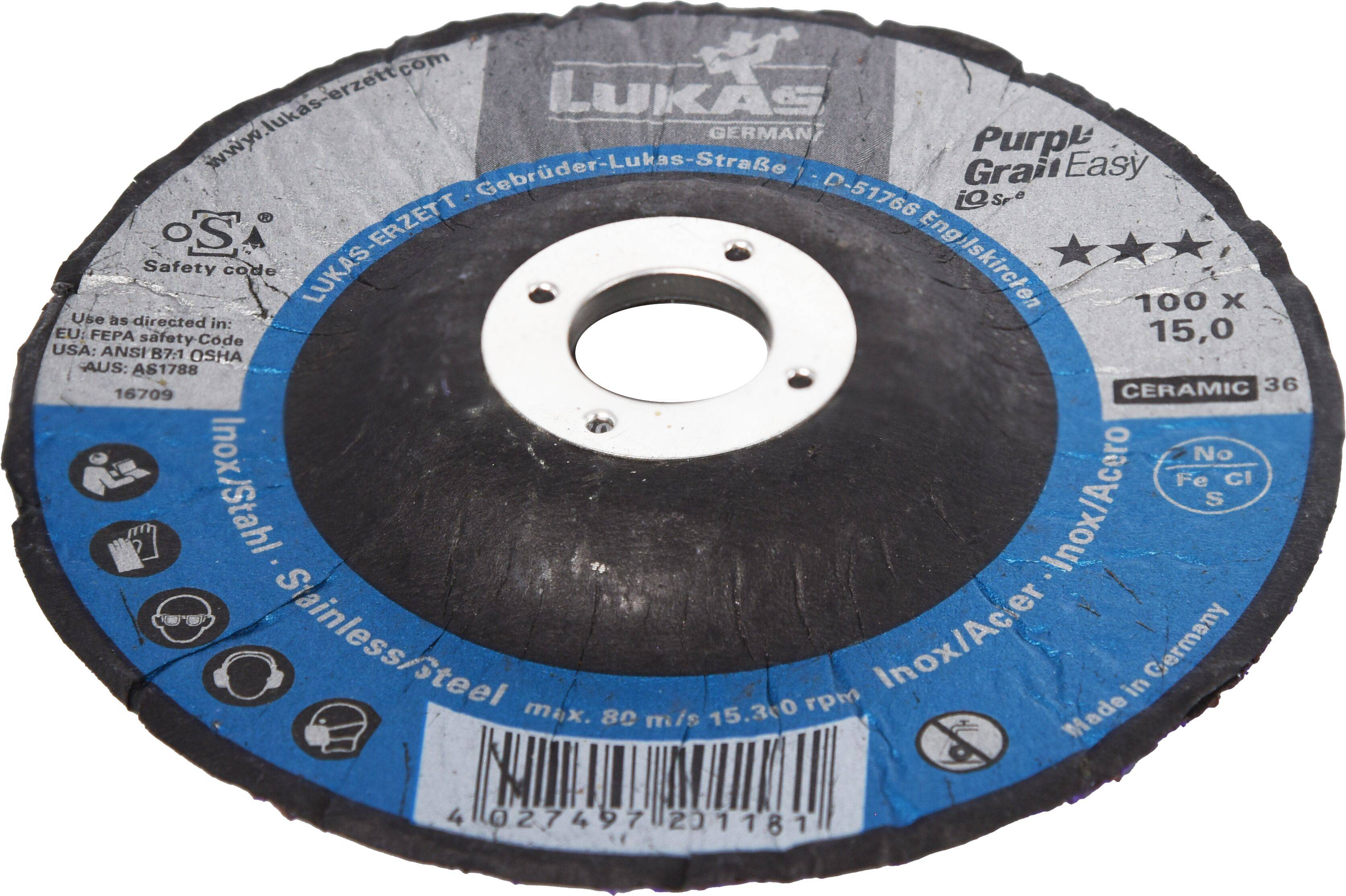 Tarcza szlifierska z niebieską etykietą. Tekst zawiera informacje o 'Stali nierdzewnej', 'Purp!Grain Easy' oraz informacje dotyczące bezpieczeństwa. Otwór centralny do mocowania.