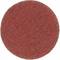 Okrągły krążek papieru ściernego o chropowatej strukturze, w kolorze rdzawobrązowym, używany do szlifowania lub wygładzania powierzchni.