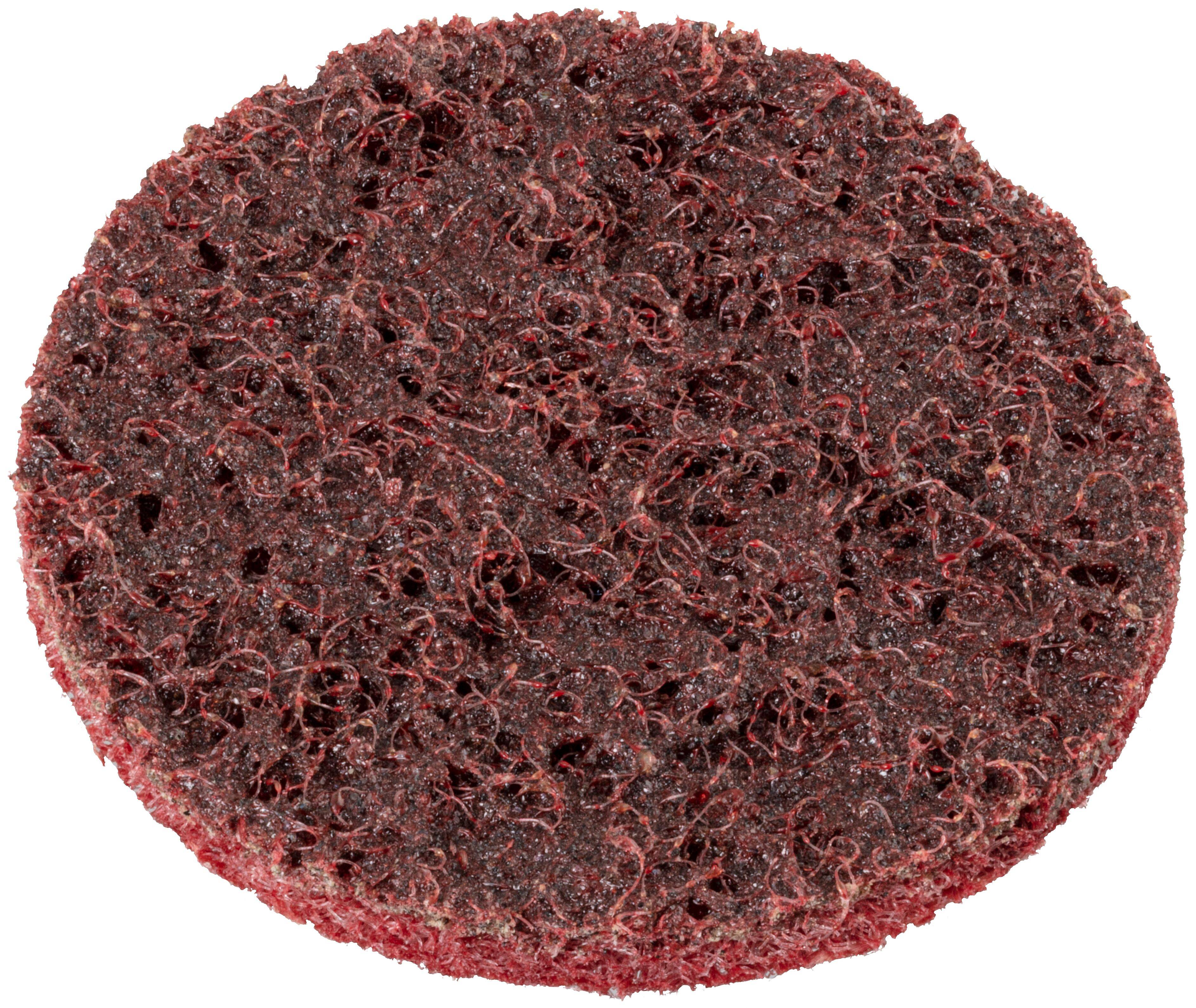 Okrągła, czerwona gąbka czyszcząca o szorstkie, włóknistej strukturze, używana do czyszczenia różnych powierzchni.