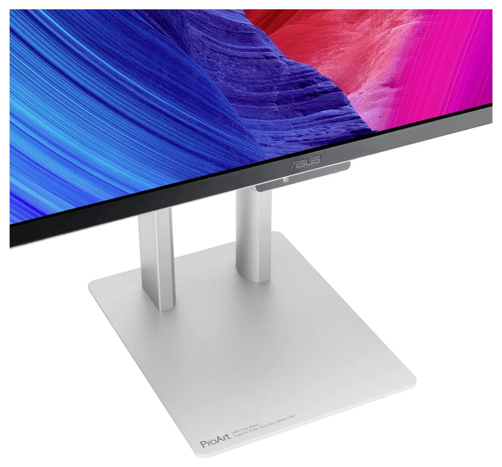 Srebrny stojak na monitor Asus z napisem 'ProArt' podtrzymuje cienki, kolorowy wyświetlacz, na którym widać abstrakcyjne niebieskie i czerwone wzory.