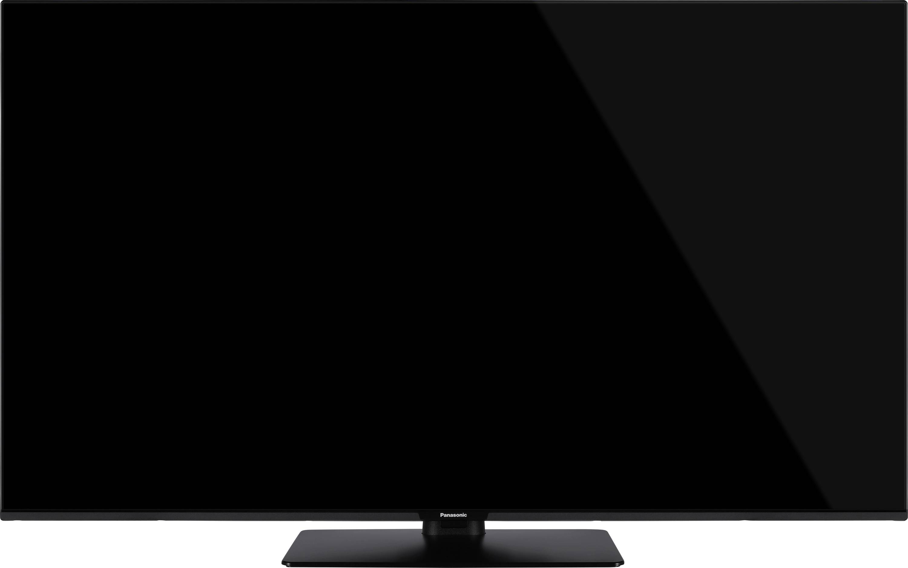 Telewizor z płaskim ekranem w czarnej ramce, stojący na centralnej podstawce, z pustym ekranem.