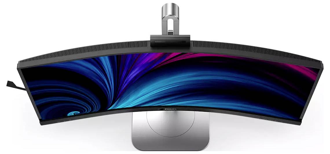 Zakrzywiony monitor widziany z góry, wyświetlający dynamiczny wzór wirujący w kolorach niebieskim i różowym na ekranie.