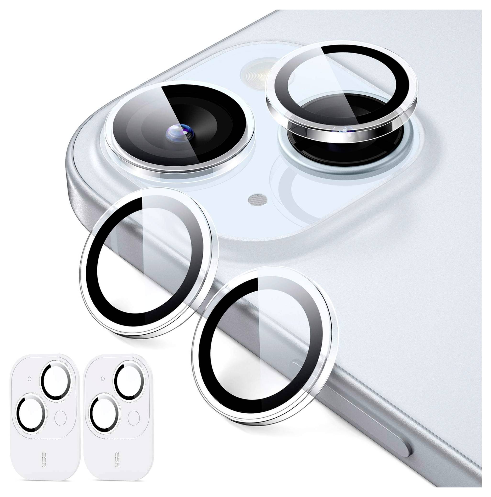 Zbliżenie smartfona z zastosowanymi osłonami obiektywów na aparacie. Obok telefonu pokazane są dwie dodatkowe osłony obiektywów.