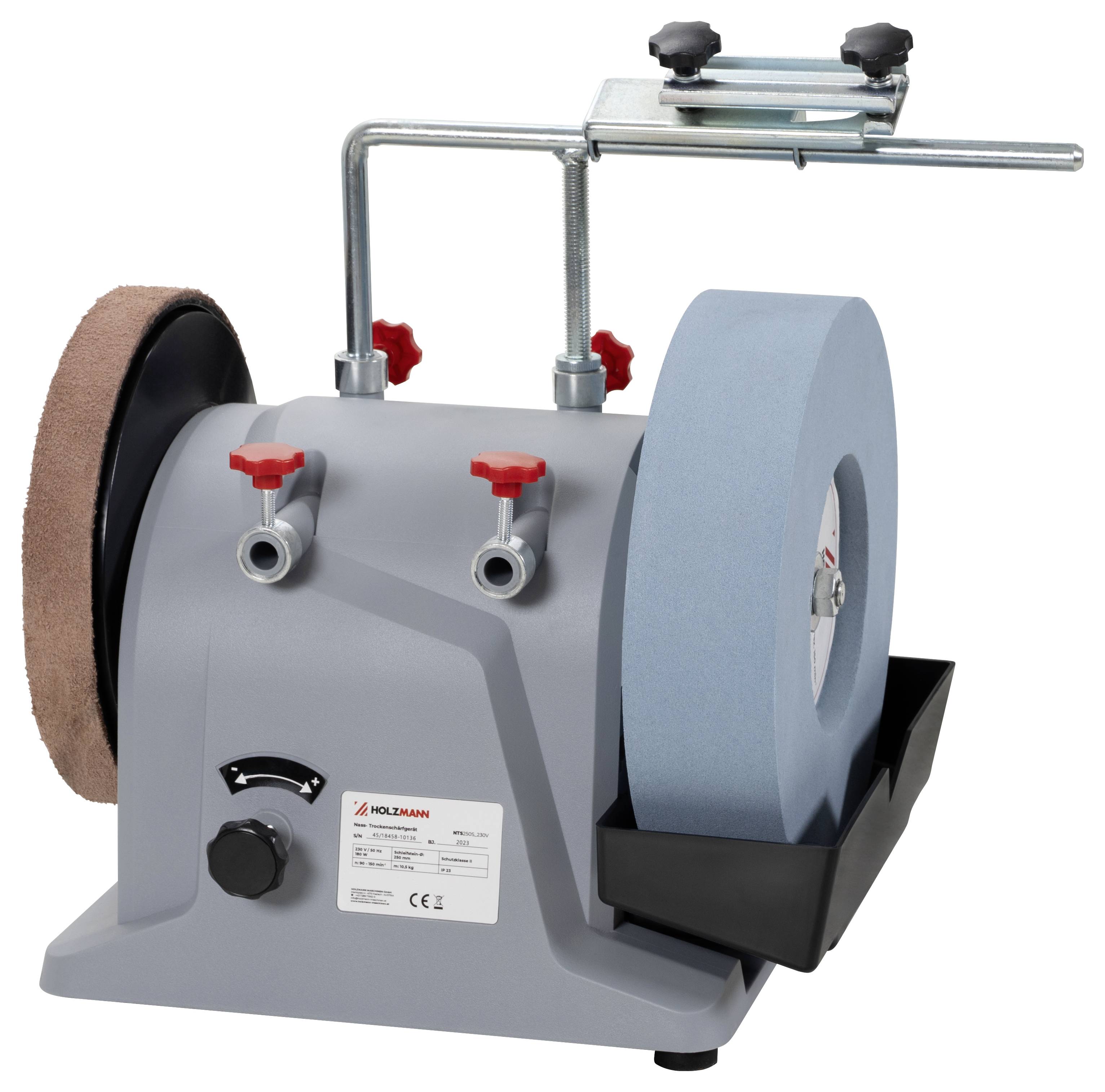 Szara szlifierka stołowa z niebieskim kołem szlifierskim i brązowym kamieniem do ostrzenia, wyposażona w czerwone pokrętła regulacyjne i wspornik mocujący na górze.