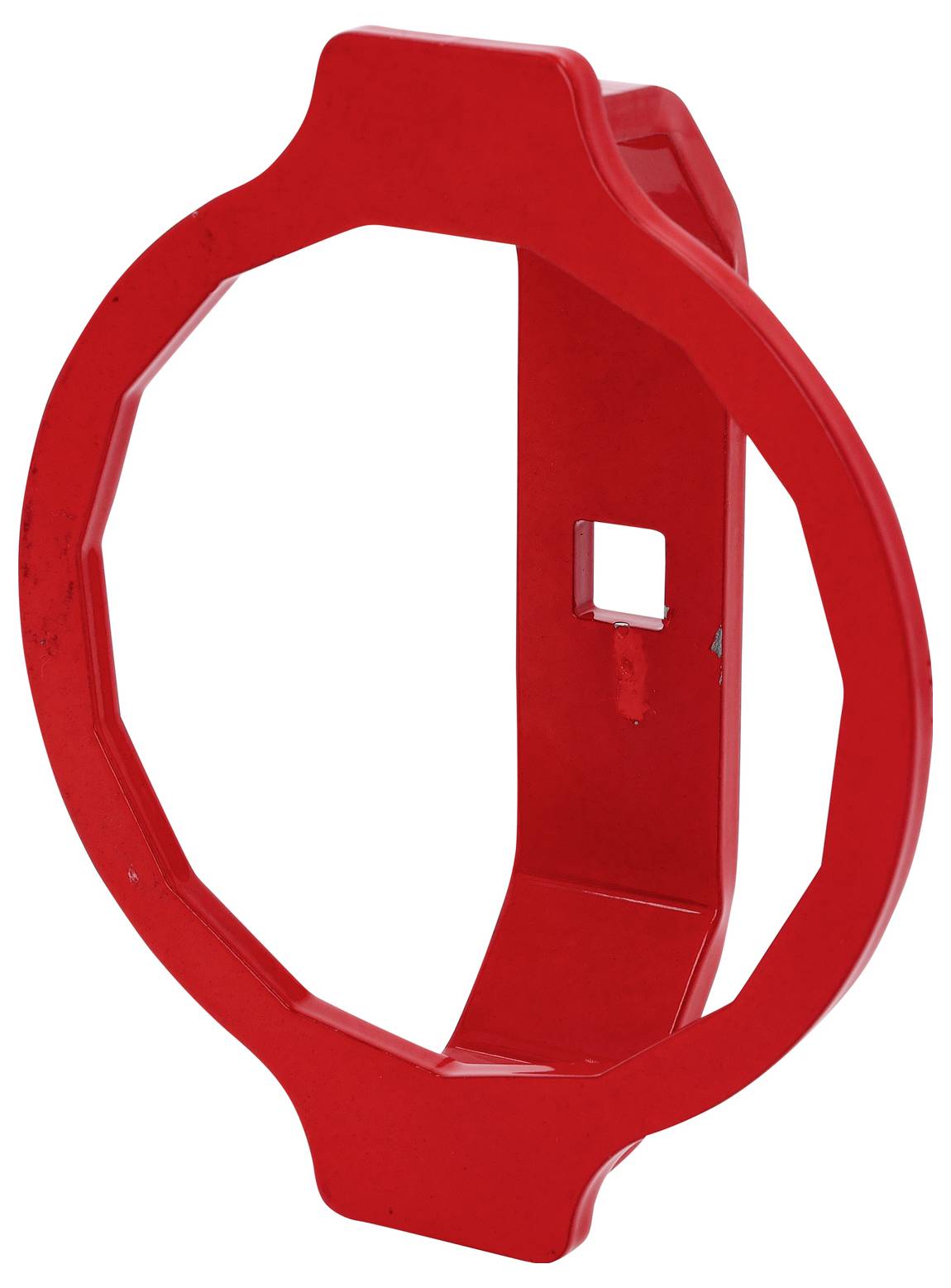 Czerwony plastikowy pierścień o wydłużonym kształcie, posiadający kwadratowy otwór w centrum.