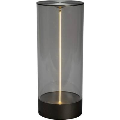 Cylindryczna lampa stołowa z przezroczystym szklanym korpusem i pionowo świecącą żarówką, umieszczona na ciemnej podstawie, emituje ciepłe, przyjemne światło otoczenia.