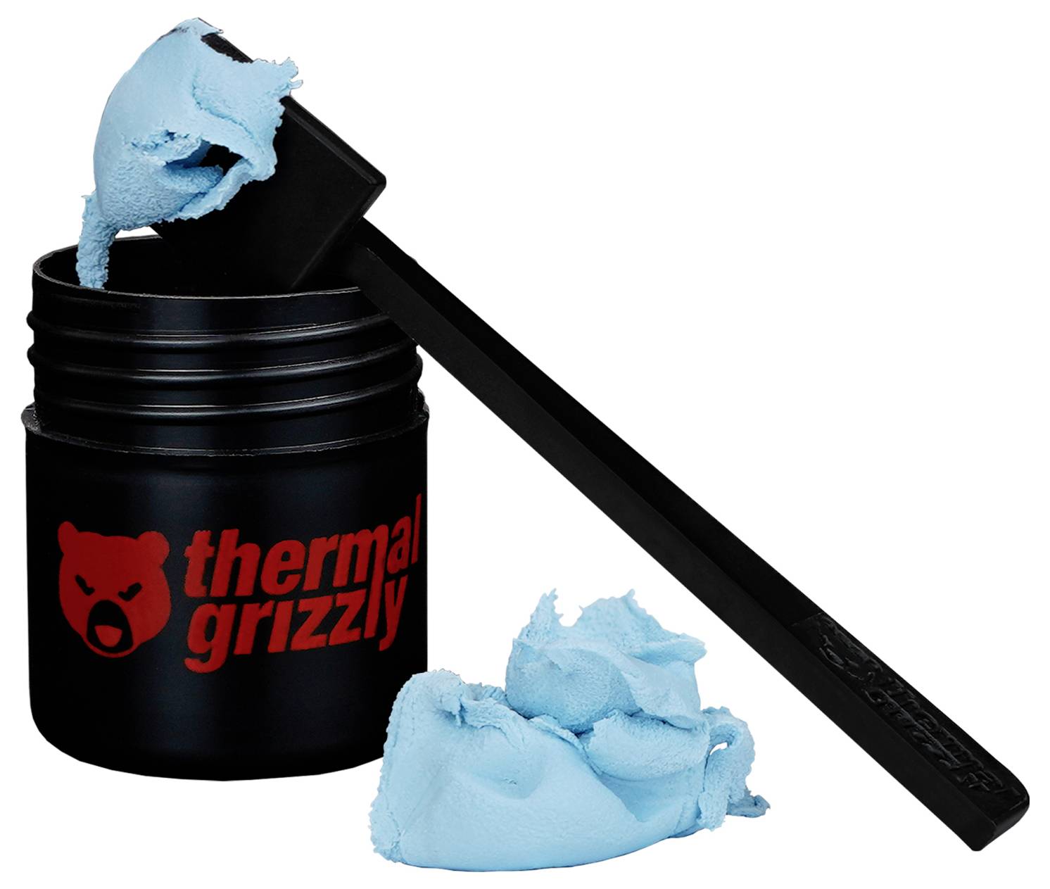 Logo 'thermal grizzly' na czarnym słoiku niebieskiej pasty termoprzewodzącej, z szpatułką trzymającą pastę nad słoikiem.