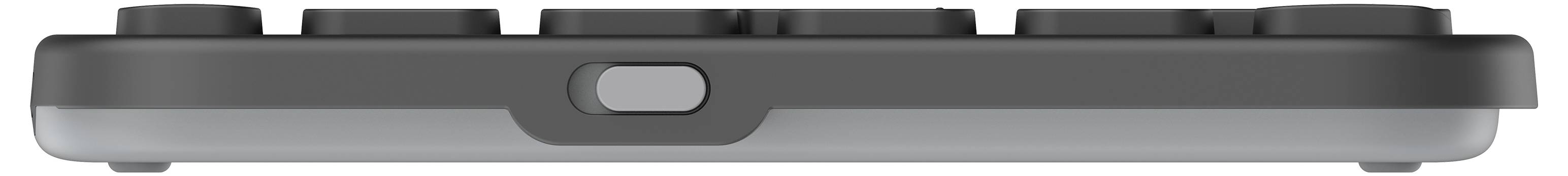 Widok z boku czarno-szarego urządzenia elektronicznego z czterema okrągłymi przyciskami na górnej powierzchni, przeznaczonego do sterowania lub wprowadzania danych.