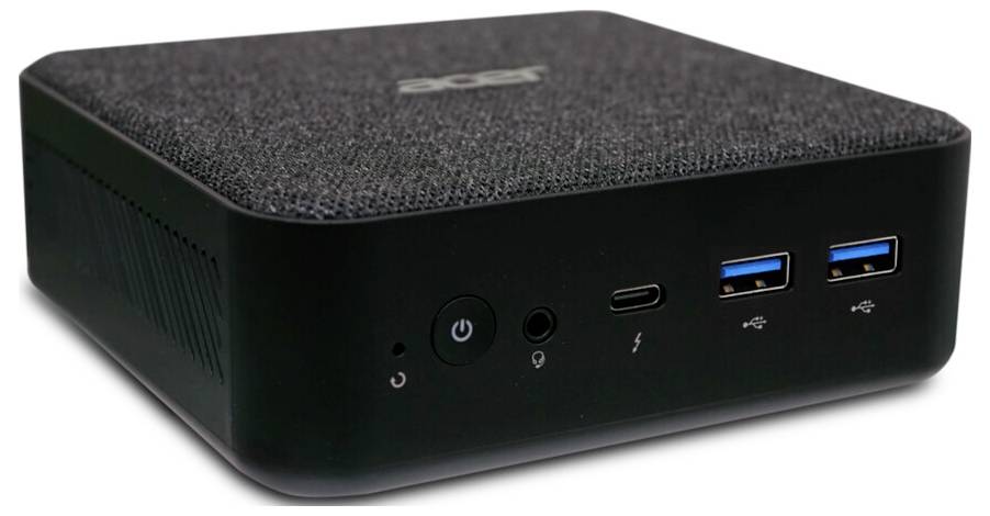Mała czarna skrzynka komputerowa z teksturowaną górną powierzchnią, wyposażona w przycisk zasilania, porty USB oraz gniazdo audio na przednim panelu.