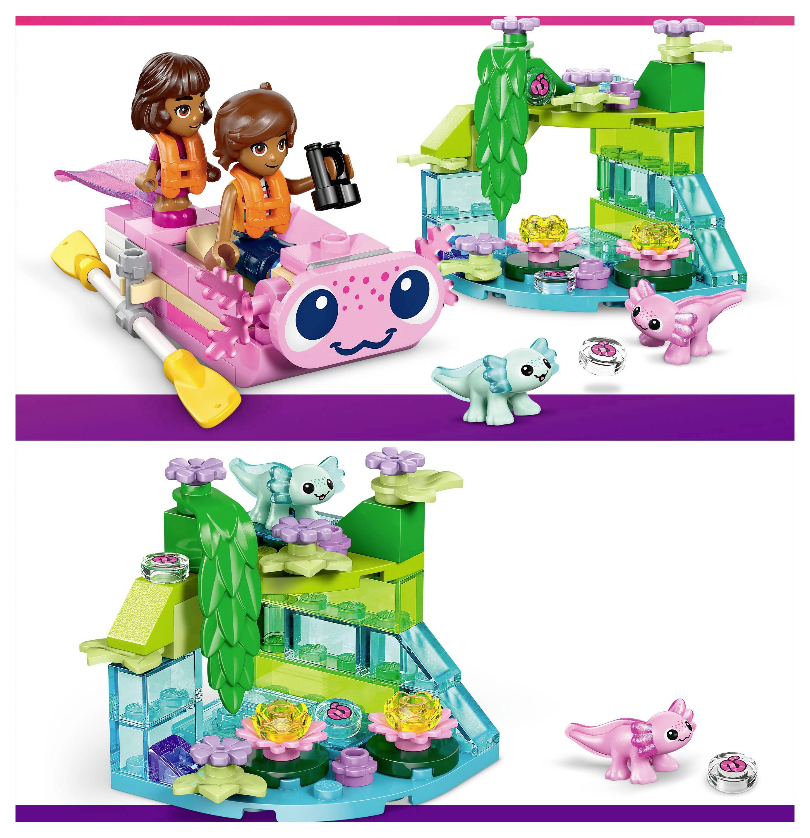 Dwie postacie w pomarańczowych strojach na różowym, wodnym pojeździe zabawkowym. W pobliżu kolorowy zestaw zabawkowy z roślinami i małymi, igraszkowymi stworkami.