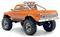 Pomarańczowa zabawkowa ciężarówka pickup z dużymi terenowymi oponami i rurą ochronną, widoczna z tyłu i boku. Na tylnej klapie nadwozia widnieje napis "Convoy".
