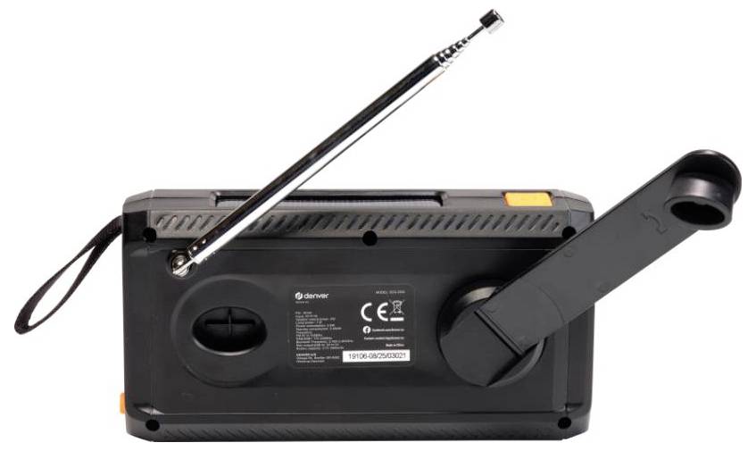 Czarne urządzenie z korbką ręczną, długą anteną i przyciskami; prawdopodobnie przenośne radio lub narzędzie awaryjne. Widoczne są etykiety i pasek.