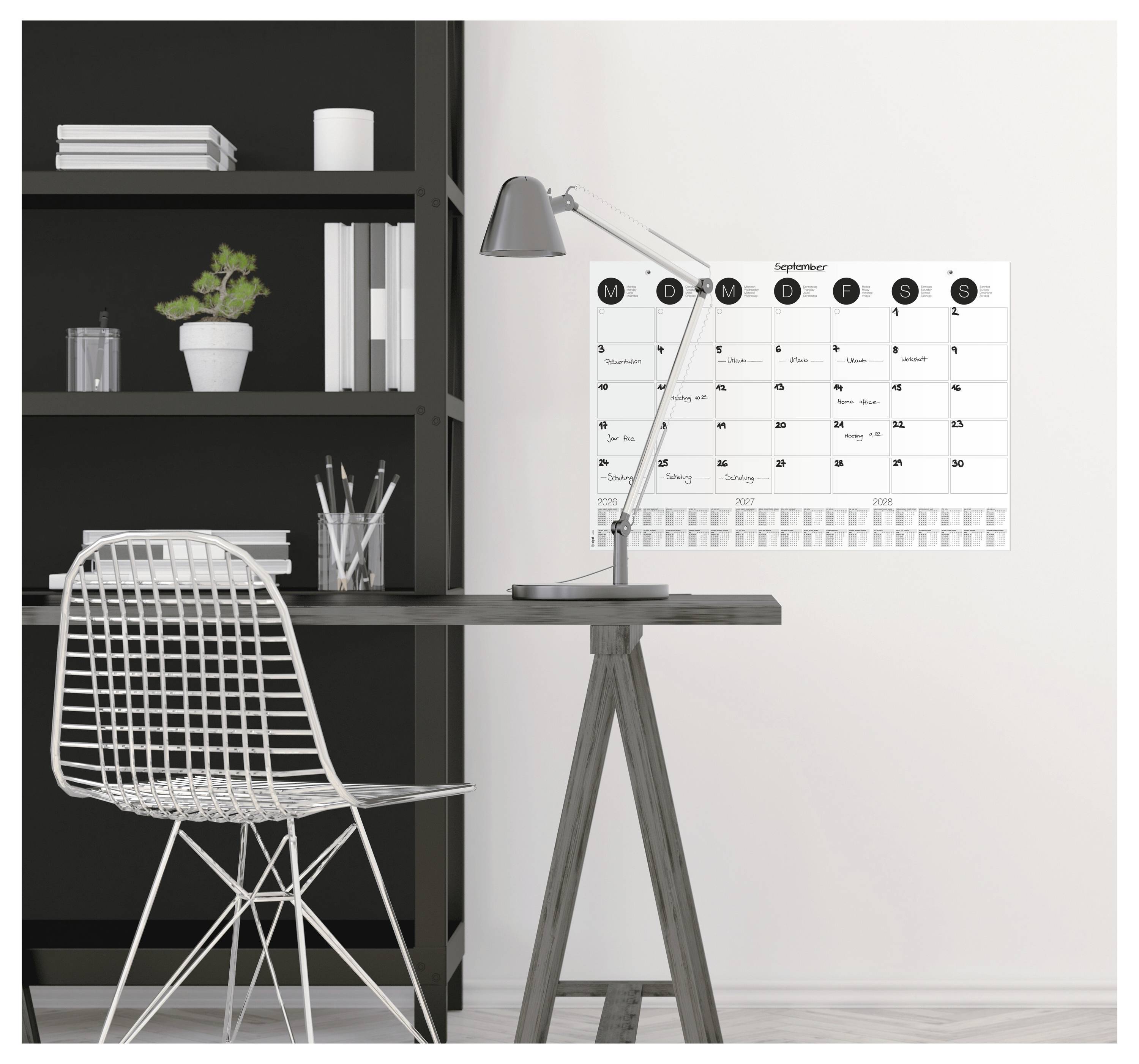 Przestrzeń robocza z krzesłem, biurkiem, lampą i ściennym kalendarzem wyświetlającym wrzesień. W tle regał z rośliną i książkami.