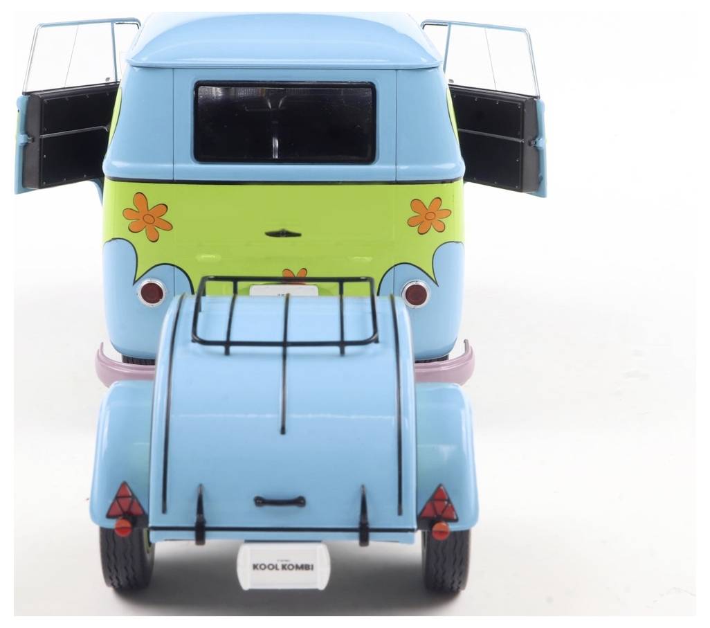 Zabawkowa furgonetka stylizowana na retro-bus VW z naklejkami w kwiaty oraz przyczepą, przypominająca zabawną, vintage'ową tematykę.
