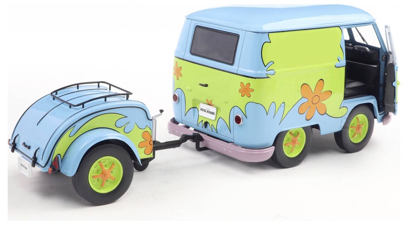 Zabawkowa furgonetka z przyczepą, pomalowana na jaskrawy niebieski kolor z zielonymi i pomarańczowymi wzorami kwiatowymi, przypominająca klasyczny design z lat 70.