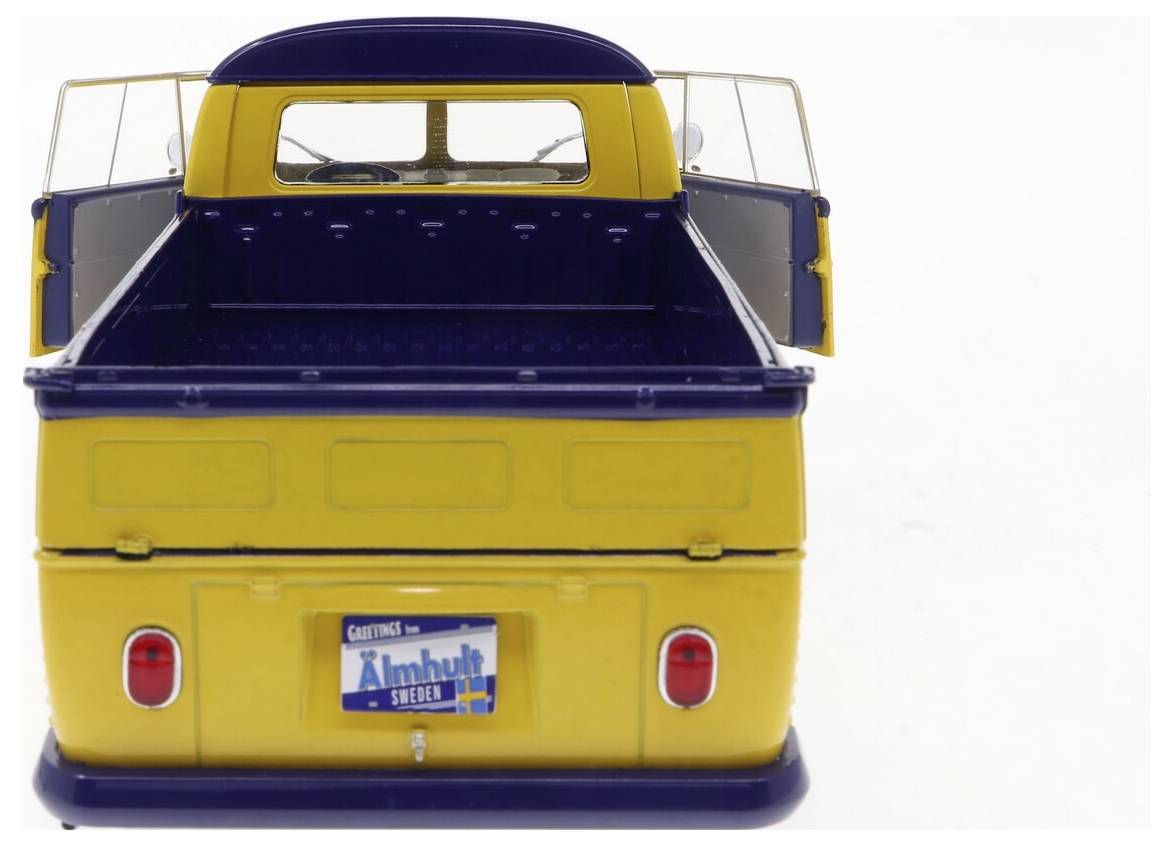 Żółta, retro-stylem utrzymana ciężarówka pickup z otwartymi podwójnymi tylnymi drzwiami, prezentująca pustą skrzynię ładunkową. Szwedzka tablica rejestracyjna z napisem 'Älmhult'.