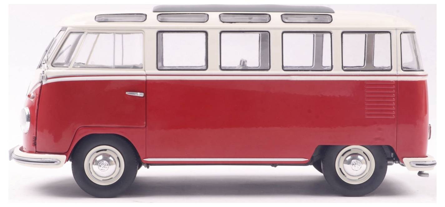 Klasyczny, czerwono-biały zabytkowy van z dużymi oknami, często kojarzony z podróżami i przygodą.