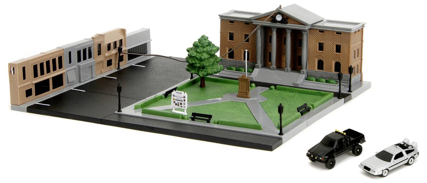 Model placu miejskiego z budynkiem sądu z kolumnami, ulicą z samochodami oraz centralnym terenem zielonym z pomnikiem i drzewami.