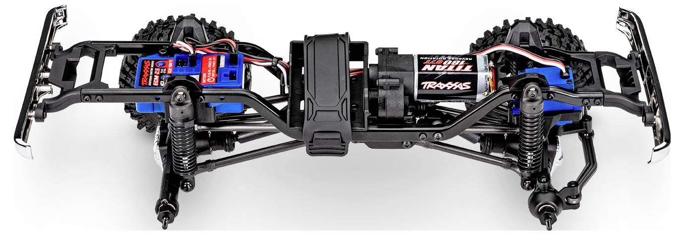 Podwozie samochodu zdalnie sterowanego z dokładnym systemem zawieszenia, silnikami elektrycznymi i okablowaniem do sterowania, prezentujące złożoność mechaniczną i projekt.