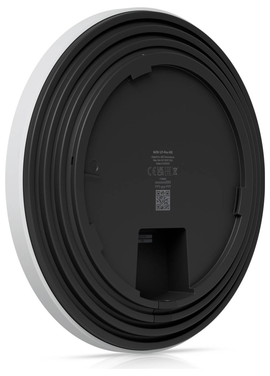 Urządzenie montowane na ścianie w kształcie koła z czarnym wzorem żeberek, dużą okrągłą podstawą i przedziałem z tyłu. Zdjęcie pokazuje widok z tyłu.