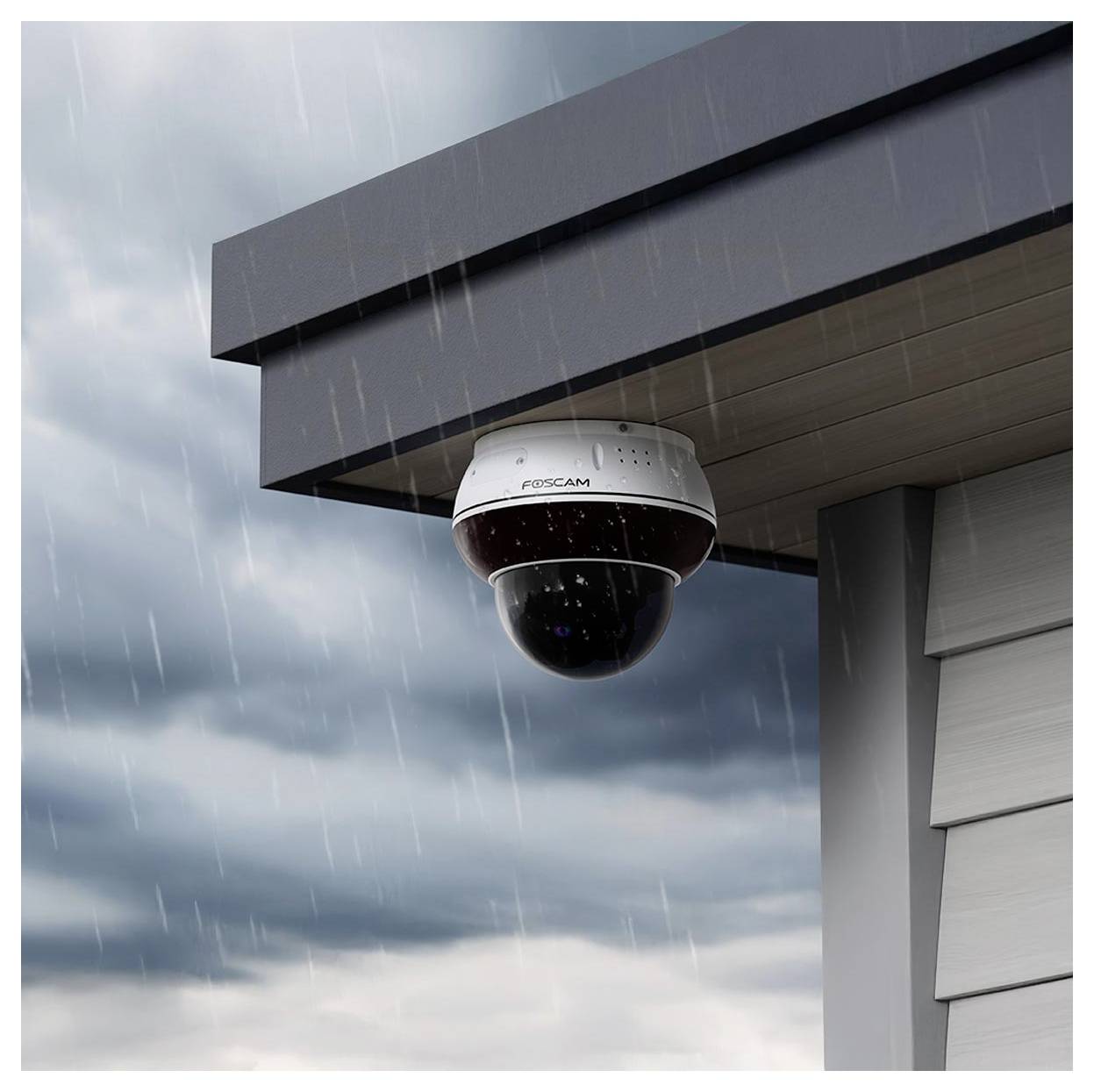 Kamera bezpieczeństwa zamontowana pod dachem budynku podczas opadu deszczu, rejestrująca scenę poniżej.