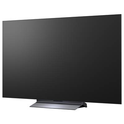 Nowoczesny telewizor płaski wyświetlający kolorowy abstrakcyjny wir tęczy na czarnym tle.