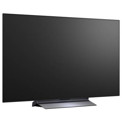Duży telewizor plaski ekranowy z czarnym pustym wyświetlaczem na stojaku na białym tle.