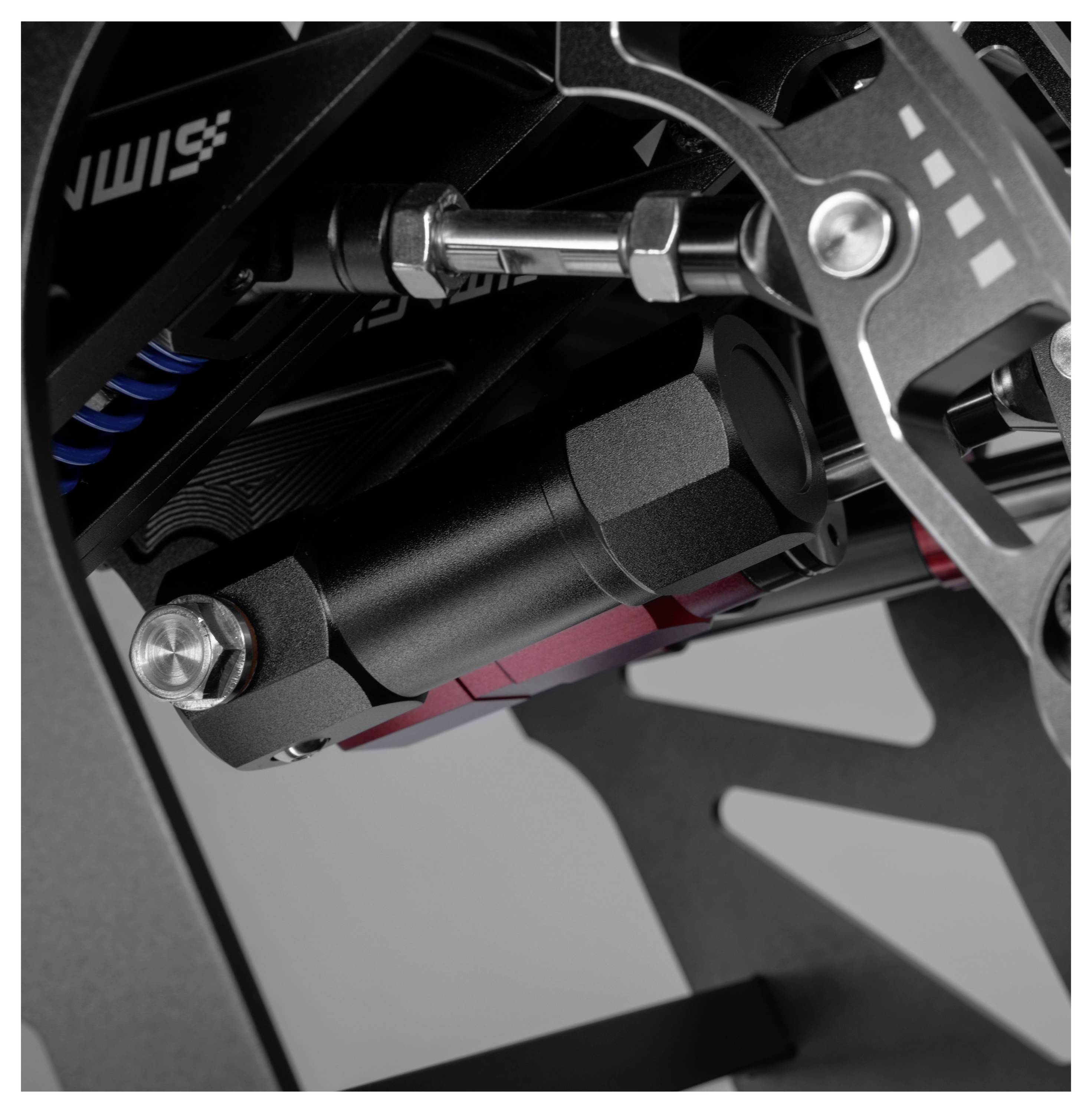 Zbliżenie na mechaniczny zawias i zespół amortyzatora na czarnej metalowej ramie urządzenia.
