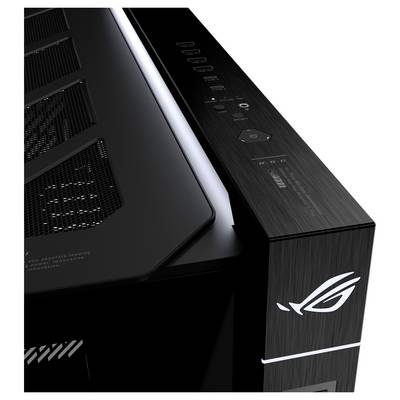 Zbliżenie na czarną obudowę komputera stacjonarnego ASUS ROG z wentylacją siatkową, przyciskami sterującymi na górze i oświetlonym logo Republic of Gamers na przednim panelu.