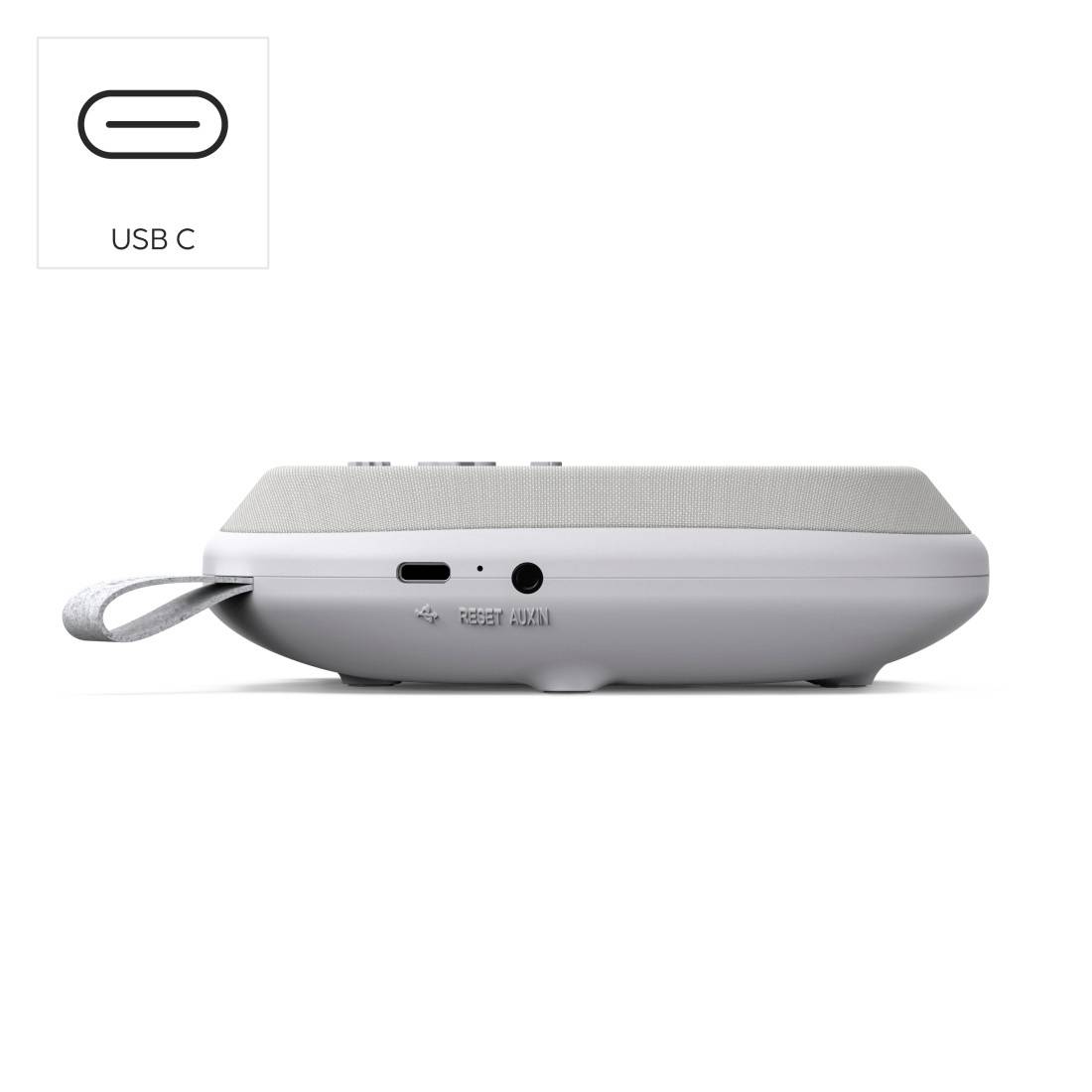 Głośnik przenośny pokazany z boku z portem USB-C i szarą pętlą do noszenia z tkaniny.