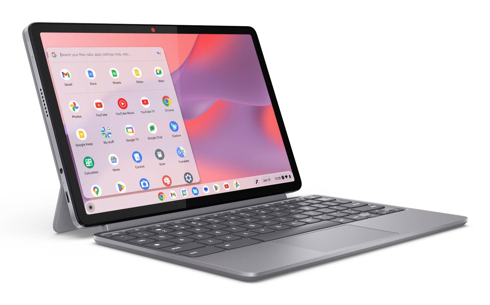 Szary tablet Chromebook w trybie laptopa z klawiaturą, wyświetlający launcher aplikacji Chrome OS na różowo-fioletowym ekranie głównym.