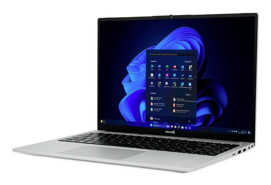 Srebrny laptop wyświetlający menu Start systemu Windows 11 na niebieskim abstrakcyjnym tle