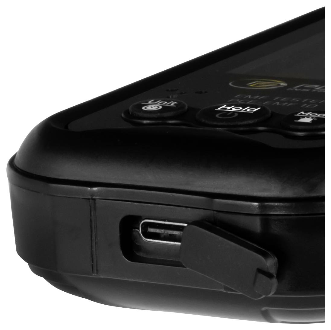 Zbliżenie czarnego przenośnego urządzenia elektronicznego pokazujące port USB z zawiasowaną pokrywą oraz przyciski sterowania oznaczone etykietami 'Unit' i 'Hold'.
