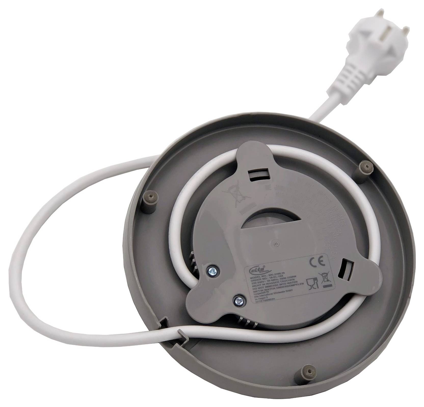 Zwinięty biały kabel zasilający i wtyczka na tylnej części okrągłego szarego urządzenia elektrycznego lub bębna kablowego.
