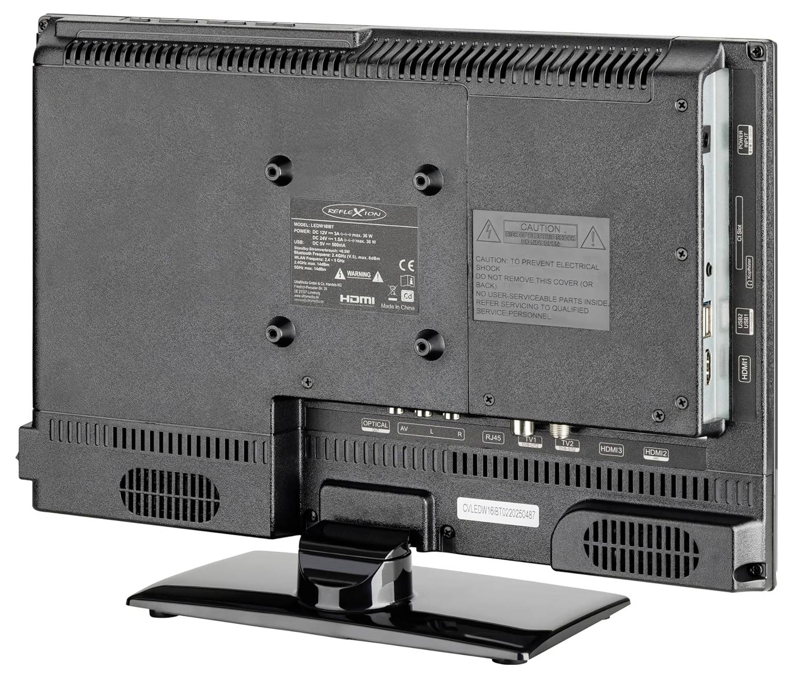 Widok od tyłu telewizora z płaskim ekranem na stojaku, pokazujący szczeliny wentylacyjne, porty wejściowe i etykiety ostrzegawcze.