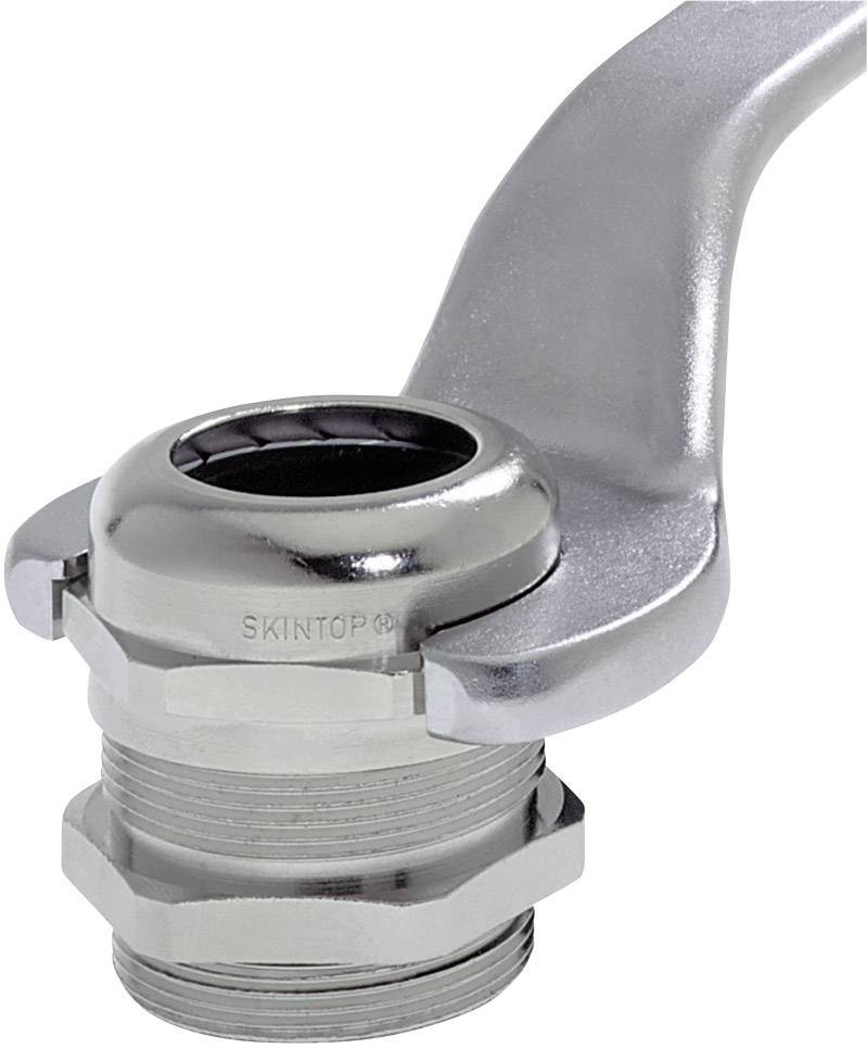 Srebrny kawałek metalu z napisem, przymocowany do cylindrycznej części gwintowanej. Może być elementem urządzenia mechanicznego.