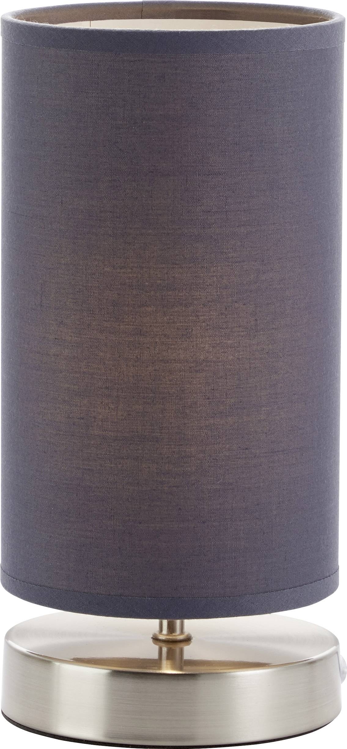 Lampa stołowa z cylindrycznym, ciemnoszarym abażurem z tkaniny, umieszczona na okrągłej, metalowej podstawie.