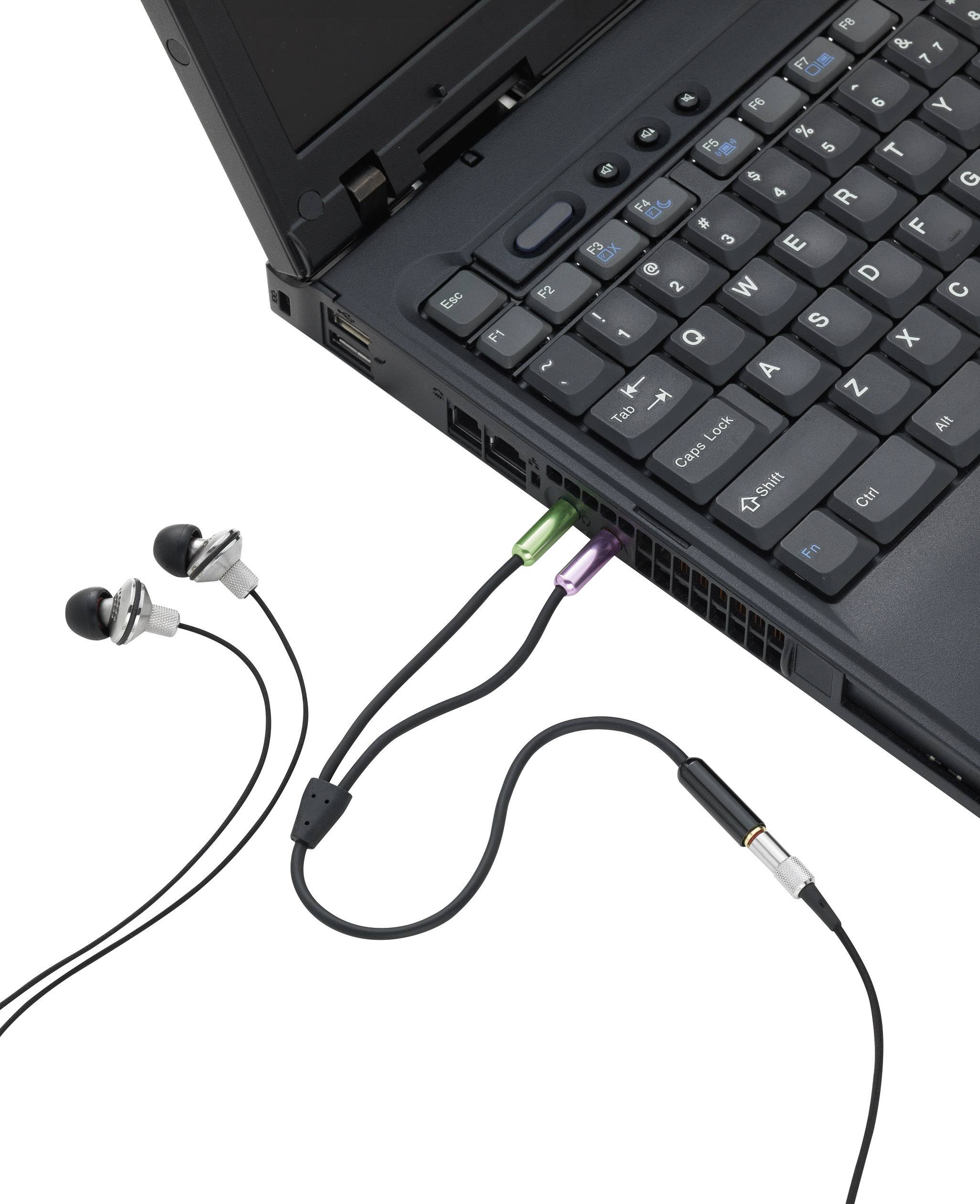 Laptop z podłączonymi słuchawkami, rozpoznawalny po zielonych i różowych gniazdach audio po stronie urządzenia.
