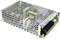 Prostokątna, metalowa obudowa zasilacza z kilkoma zaciskami po prawej stronie. Posiada otwory wentylacyjne do chłodzenia.