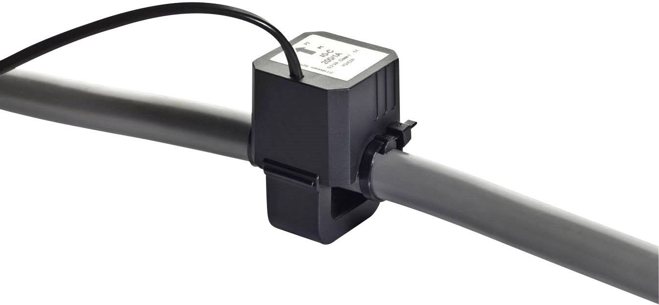 Czarny czujnik lub złączka zamocowany na szarym przewodzie; kable odchodzą od czujnika.