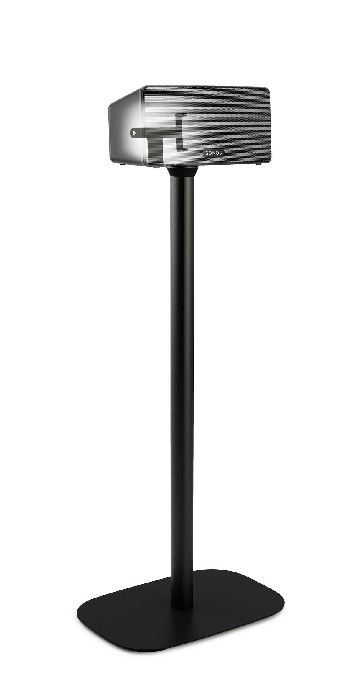 Czarny, kwadratowy głośnik na wysokim, smukłym stojaku. Przestrzeń jest urządzona minimalistycznie i nowocześnie.