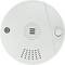 Okrągły czujnik dymu z otworami wentylacyjnymi i przyciskiem testowym. Zaprojektowany do wykrywania dymu i ostrzegania w przypadku pożaru.