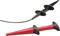 Dwie sondy pomiarowe: jedna czarna, druga czerwona, obie z ergonomicznymi uchwytami. Służą do pomiarów elektrycznych i diagnostyki.