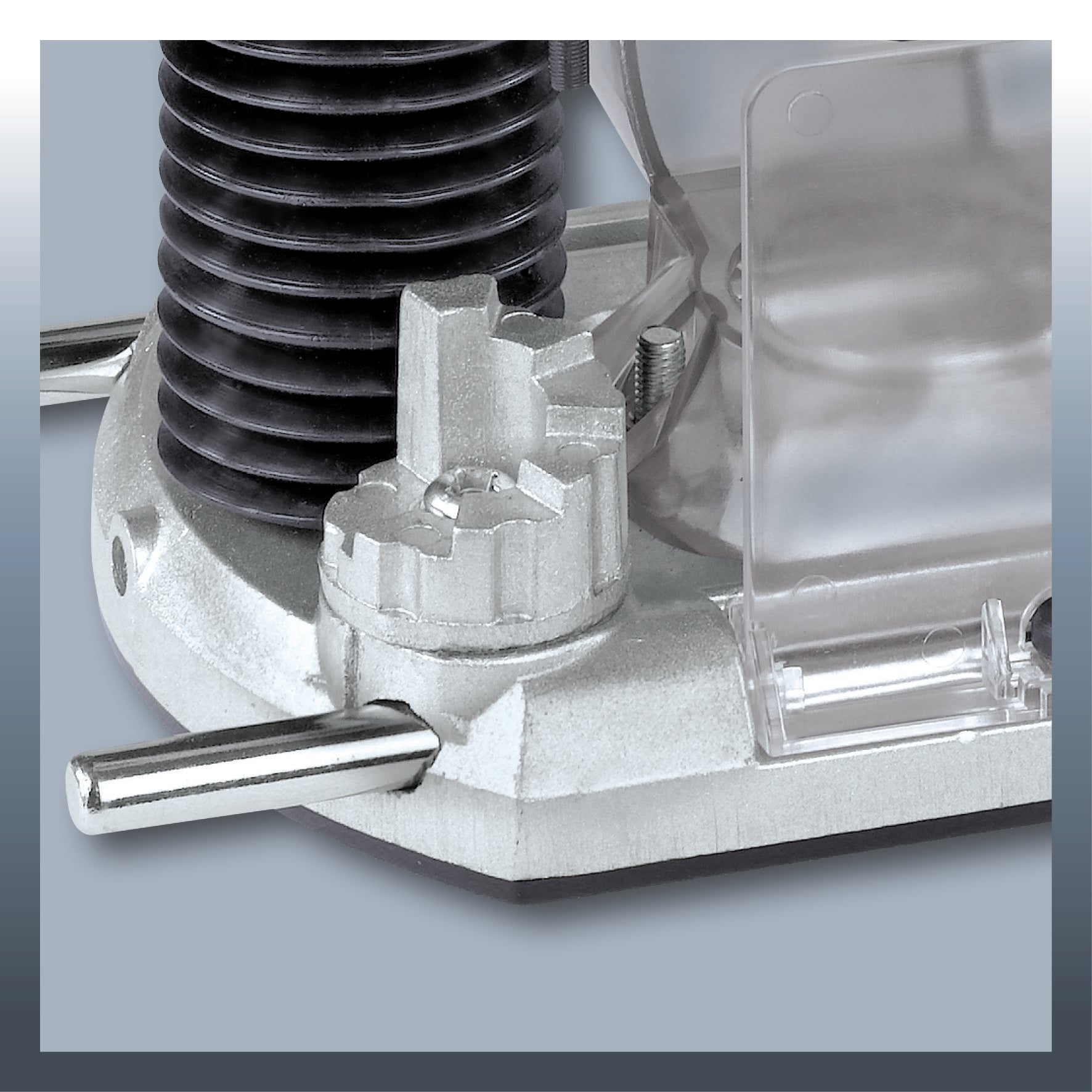 Zbliżenie metalowo-plastikowego urządzenia z widoczną sprężyną i mechanizmem zębatym, prawdopodobnie będącego częścią narzędzia lub maszyny.