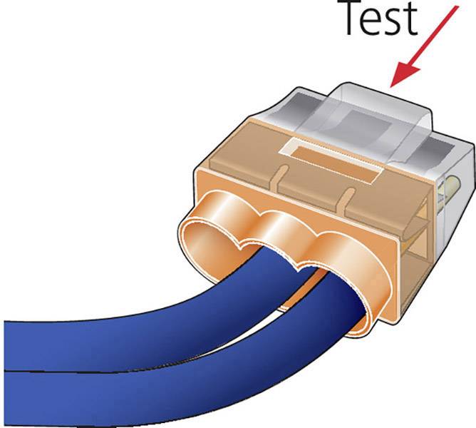 Dwa niebieskie kable są wprowadzone do przezroczystej złączki. Czerwona strzałka wskazuje obszar oznaczony napisem 'Test'.
