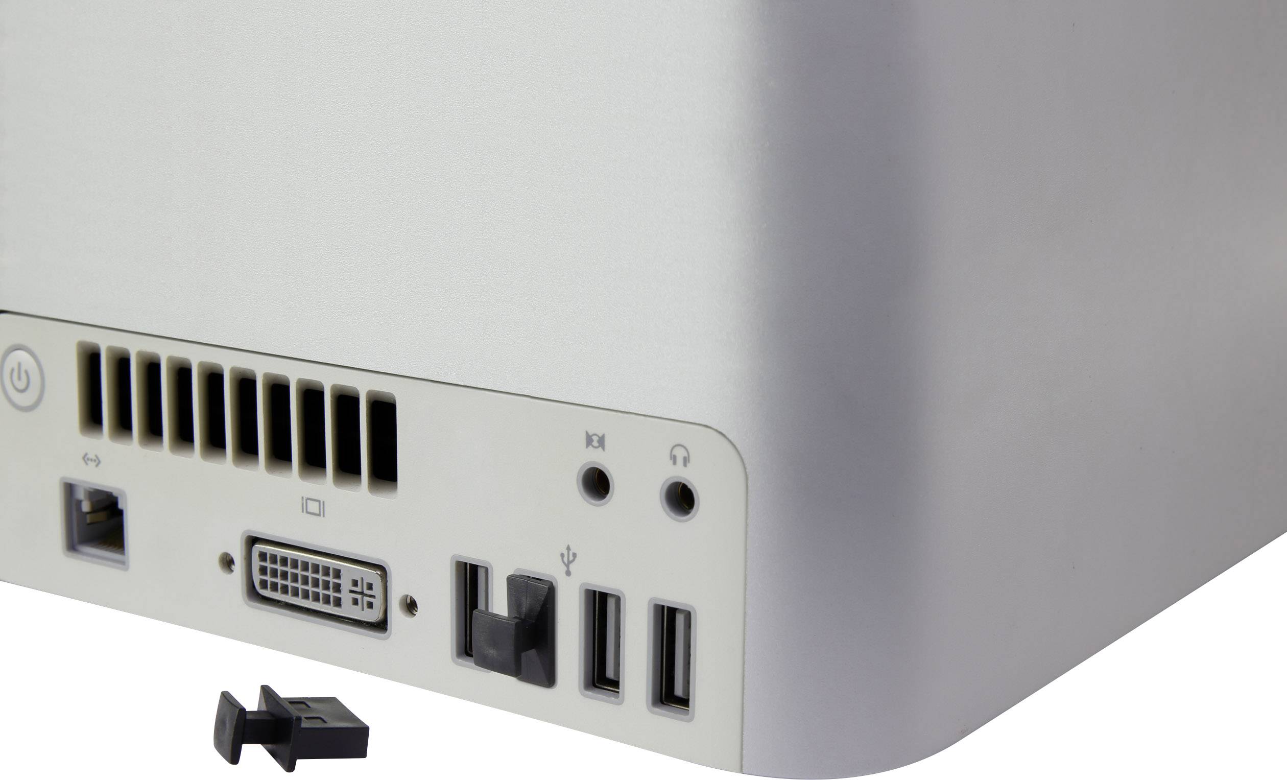 Tylna część komputera pokazuje kilka złączy, w tym porty USB, złącze DVI oraz kratkę wentylacyjną. Przed nią leży zdejmowana część.